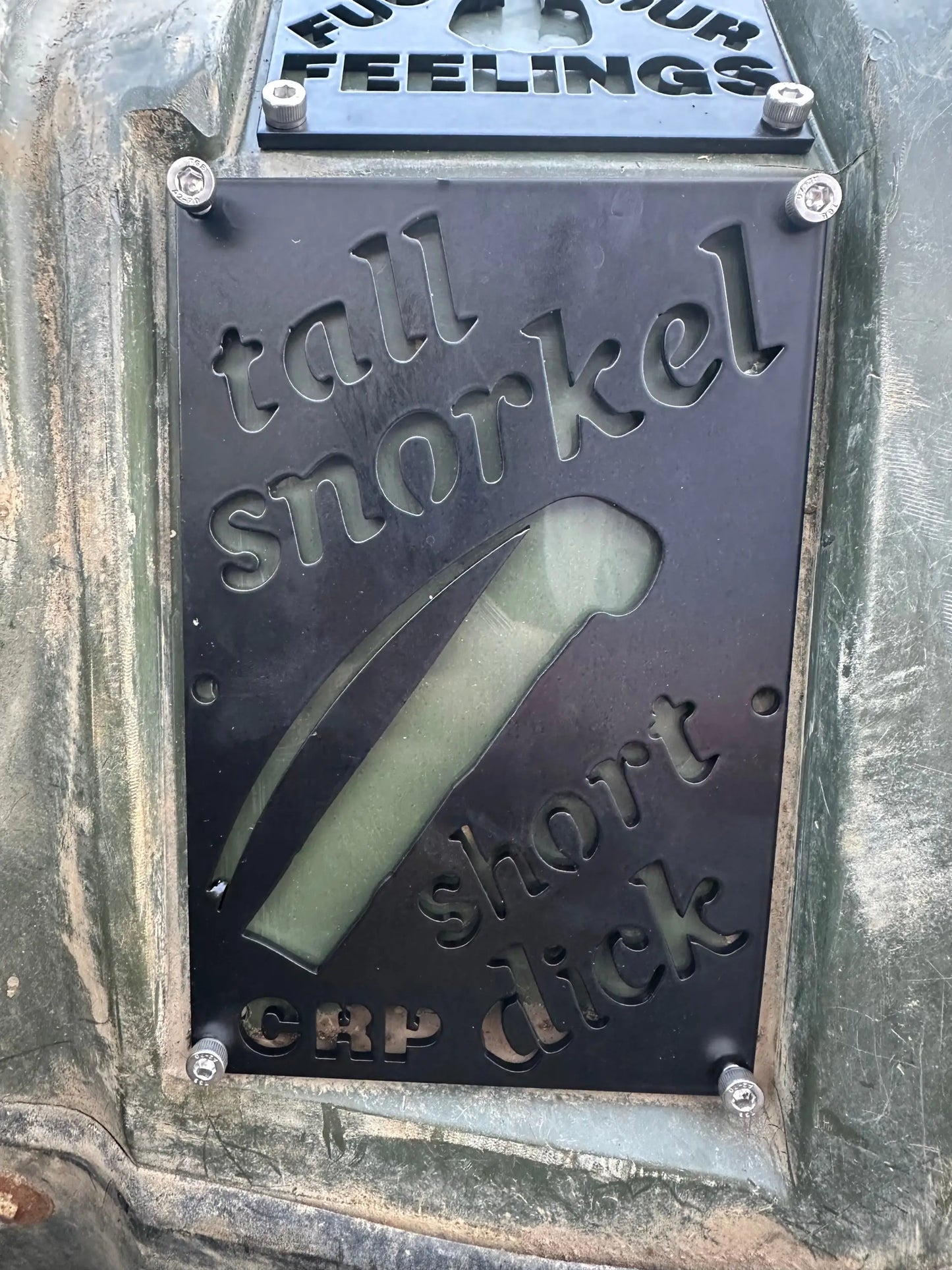 Black metal honda custom 3mm fender safety plate with engraved text and snorkel cutout on weathered green surface