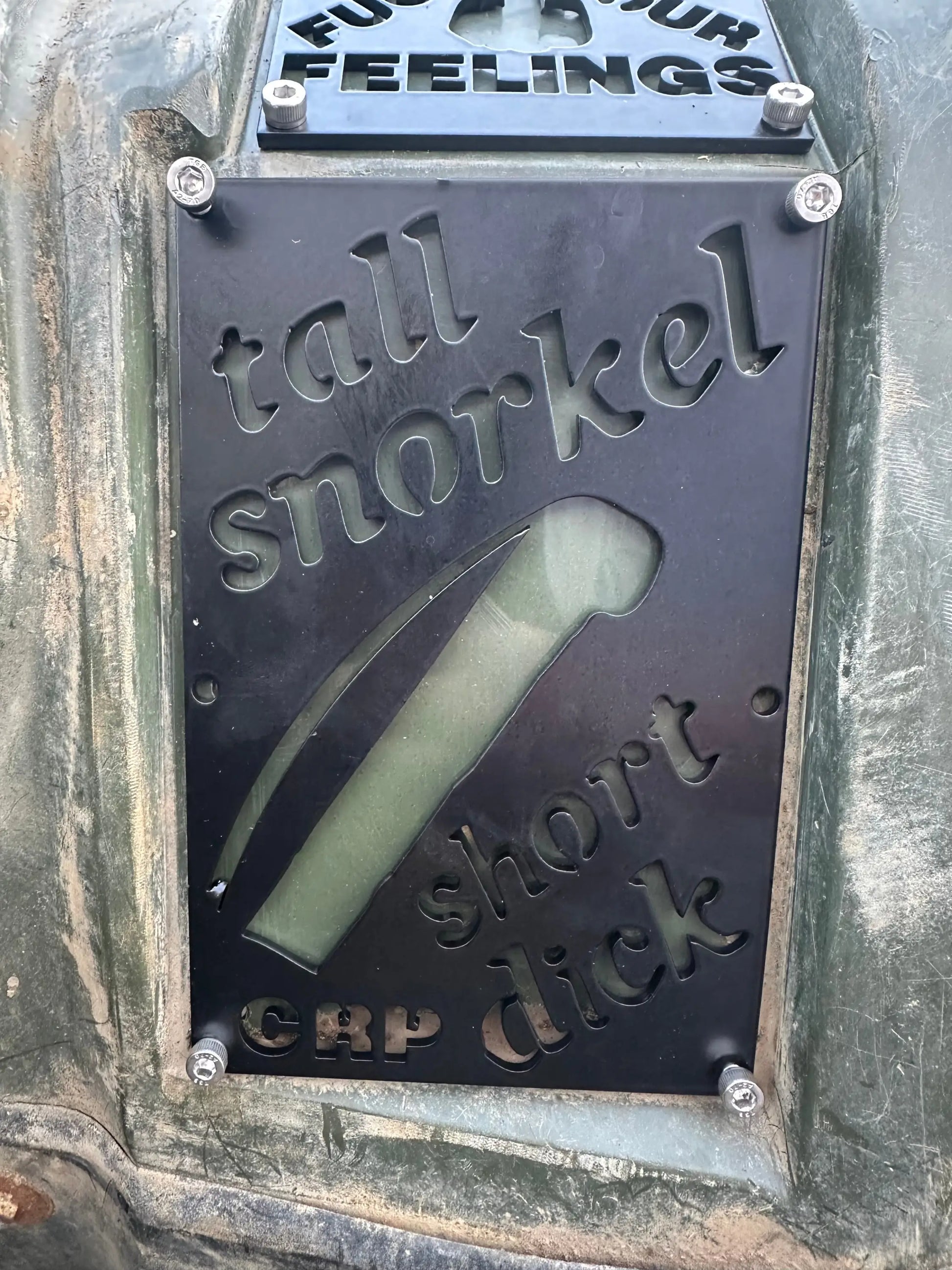 Black metal honda custom 3mm fender safety plate with engraved text and snorkel cutout on weathered green surface