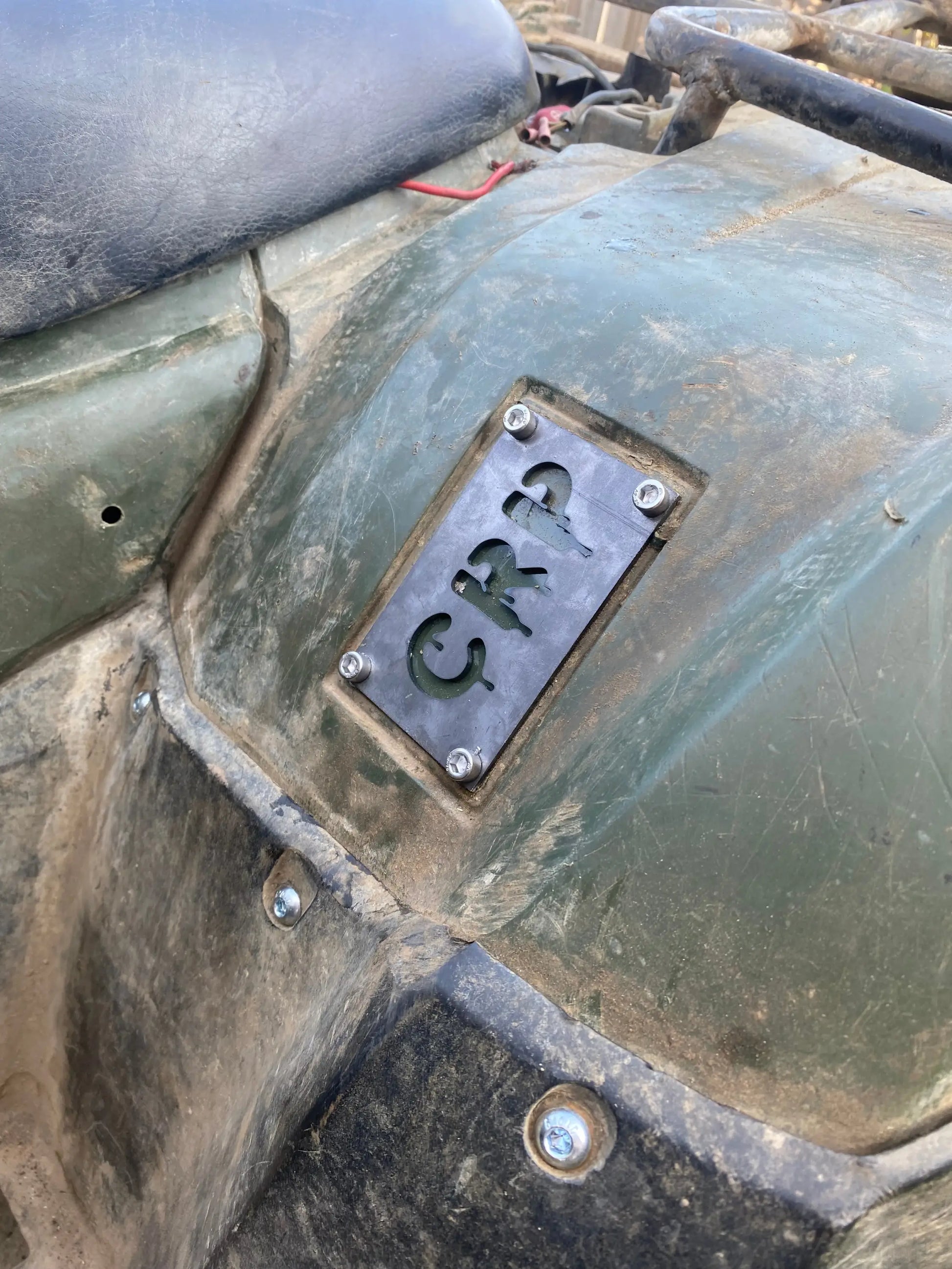 Dark gray metal honda custom 3mm fender safety plate with crp cut out mounted on green atv fender