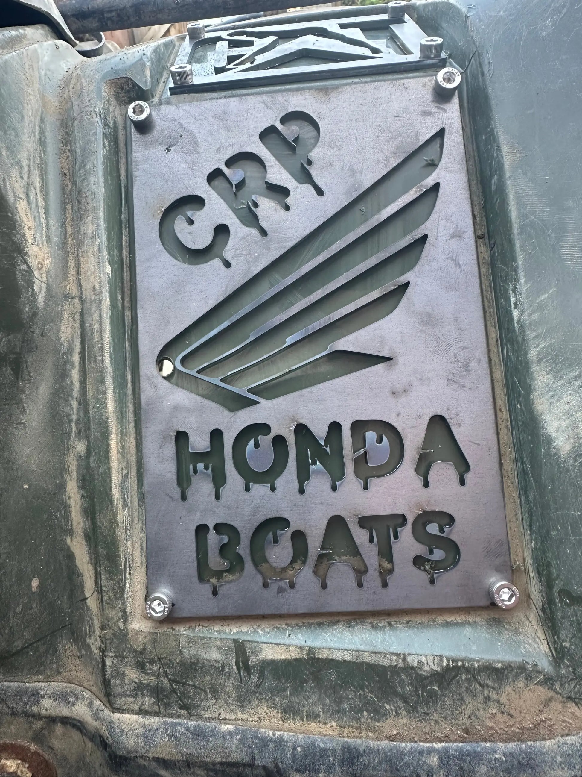 A weathered metallic honda custom 3mm fender safety plate with crp and honda boats engraving and wing cutouts