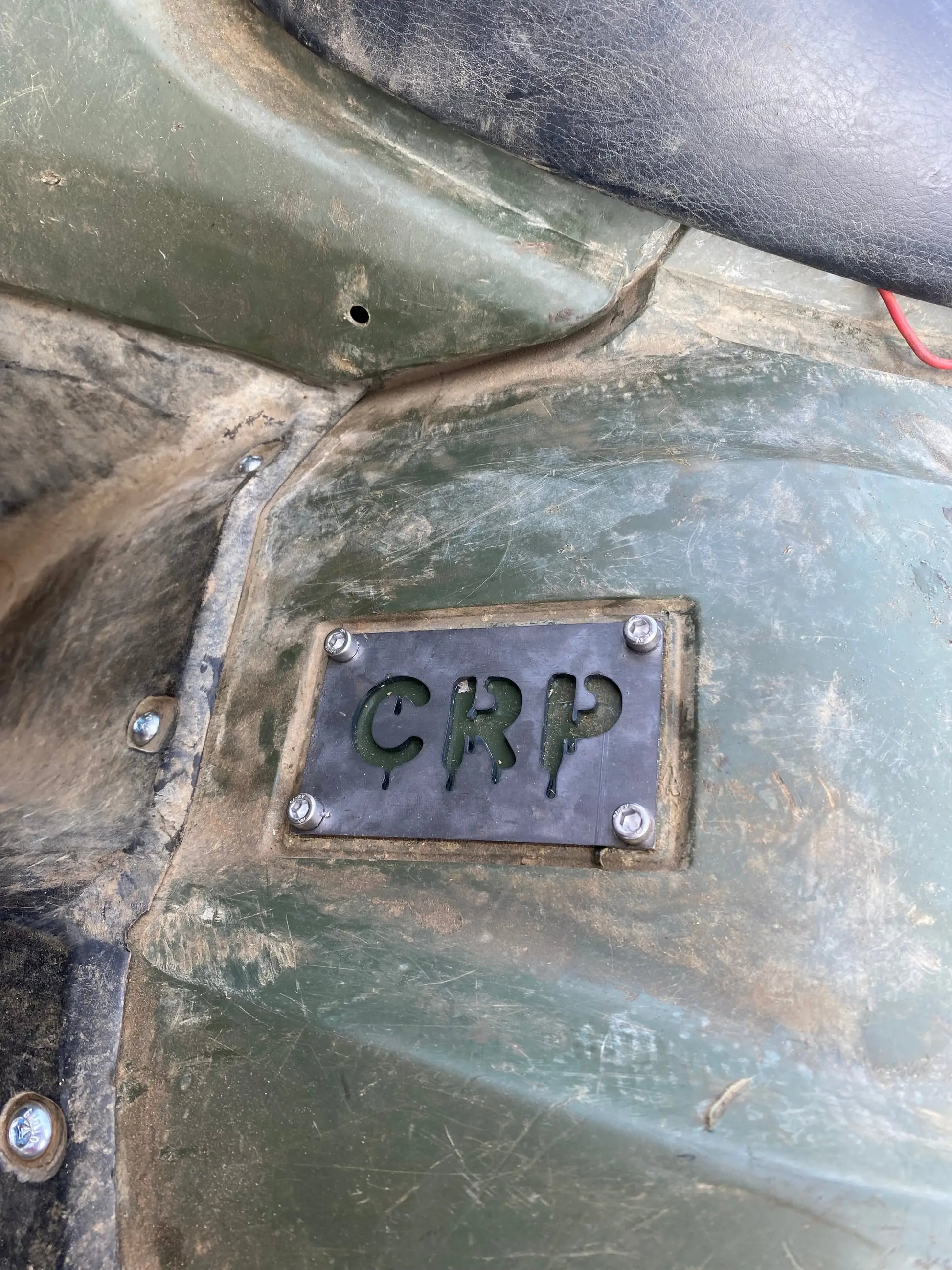 Dark metal rectangular honda custom 3mm fender safety plate with crp cutout secured by four screws