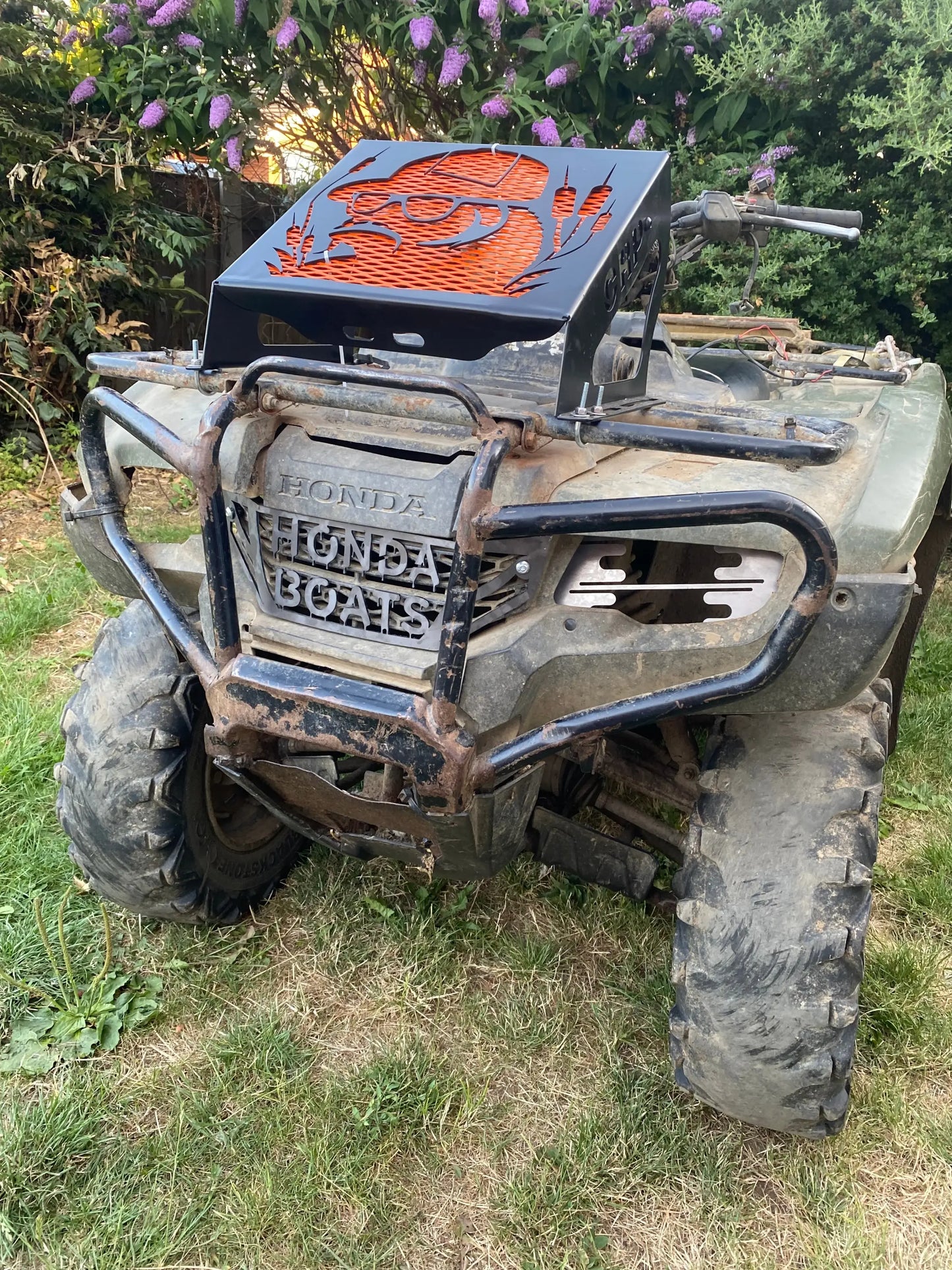 Black metal grill with orange laser cut design mounted on honda atv for foreman 420 500 520 radiator relocation kit
