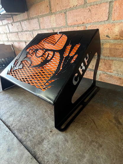 Black metal fire pit with orange mesh insert and stylized wolf design suitable for honda foreman radiator kit use