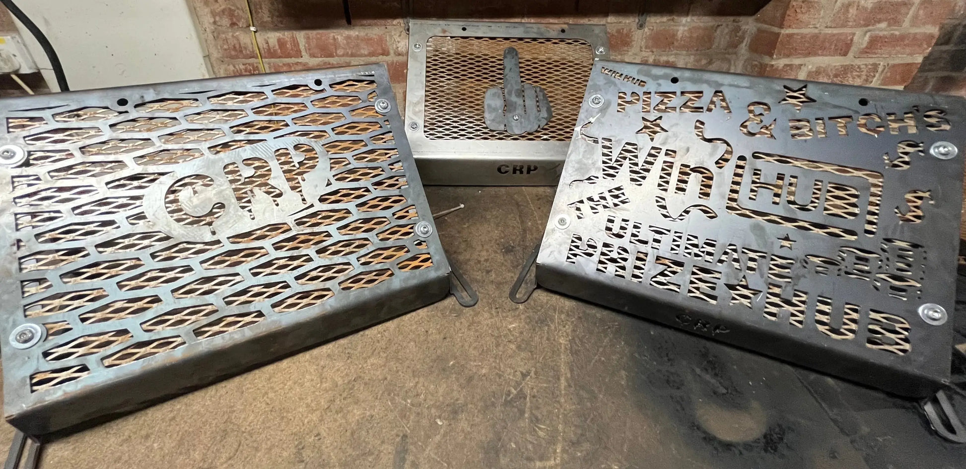 Three metallic laser-cut grill covers with engraved designs and crp branding for kawasaki brute force 750 radiator kit