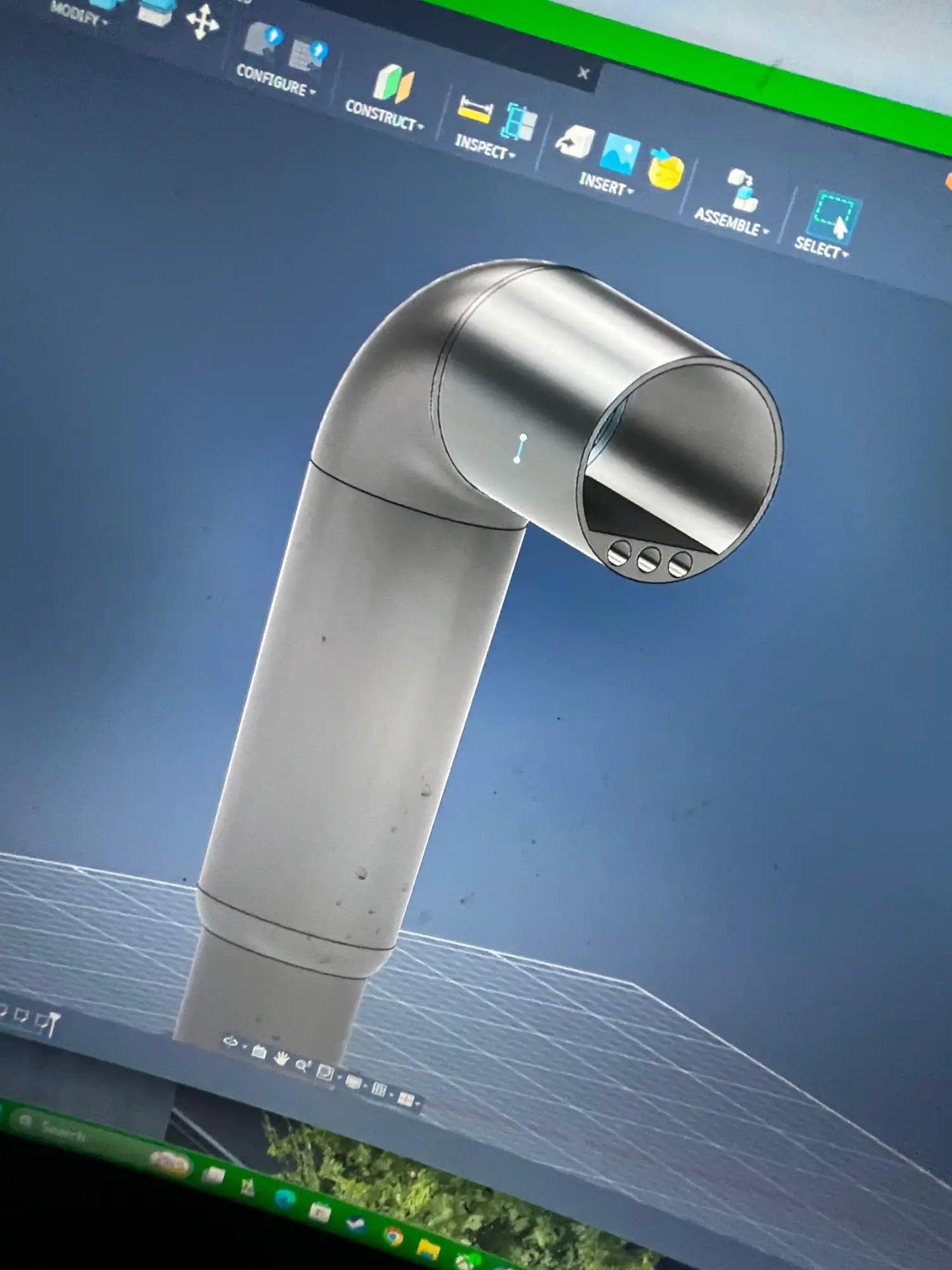 A sleek, metallic silver robotic arm with a smooth cylindrical body and articulated joint.