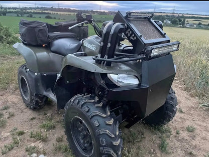 Black armored Suzuki Kingquad 500 700 750 atv with rugged off-road tires and mounted led light bar for radiator relocation