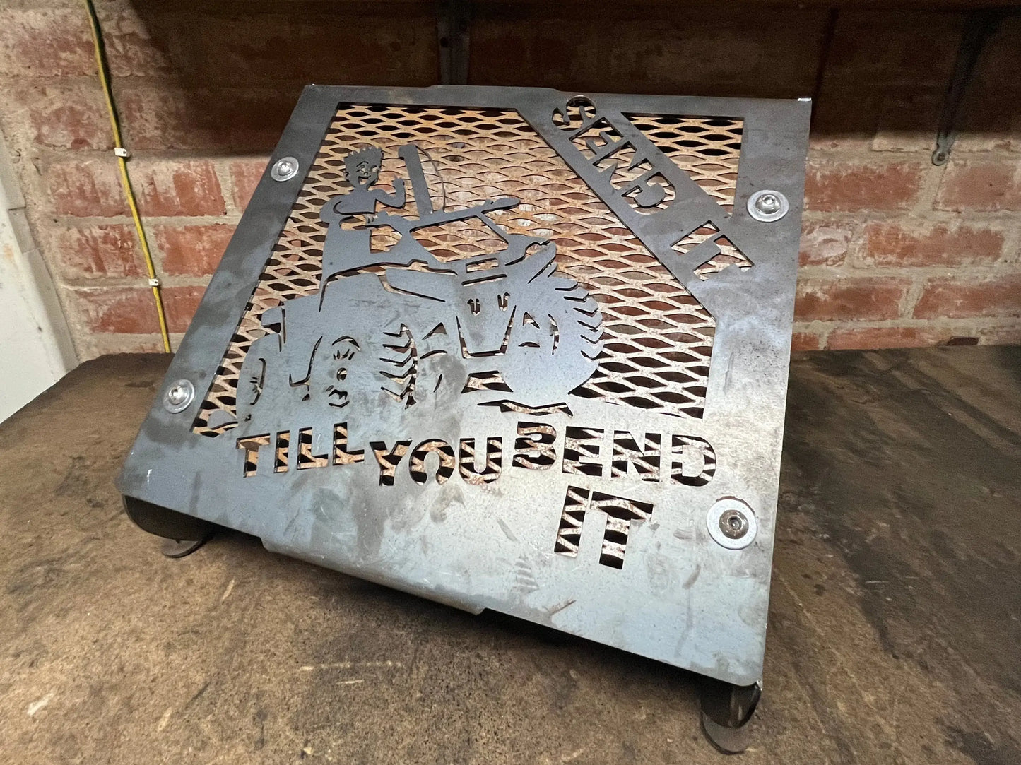 Gray metal fire pit with tractor cut-out design and bend it till you bend it engraving for suzuki kingquad radiator kit