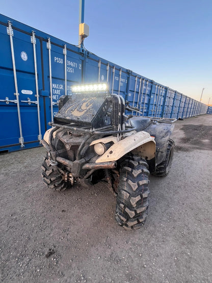 Muddy beige and black yamaha yfz450 atv with rugged tires and led light bar shown with heavy-duty radiator relocation kit