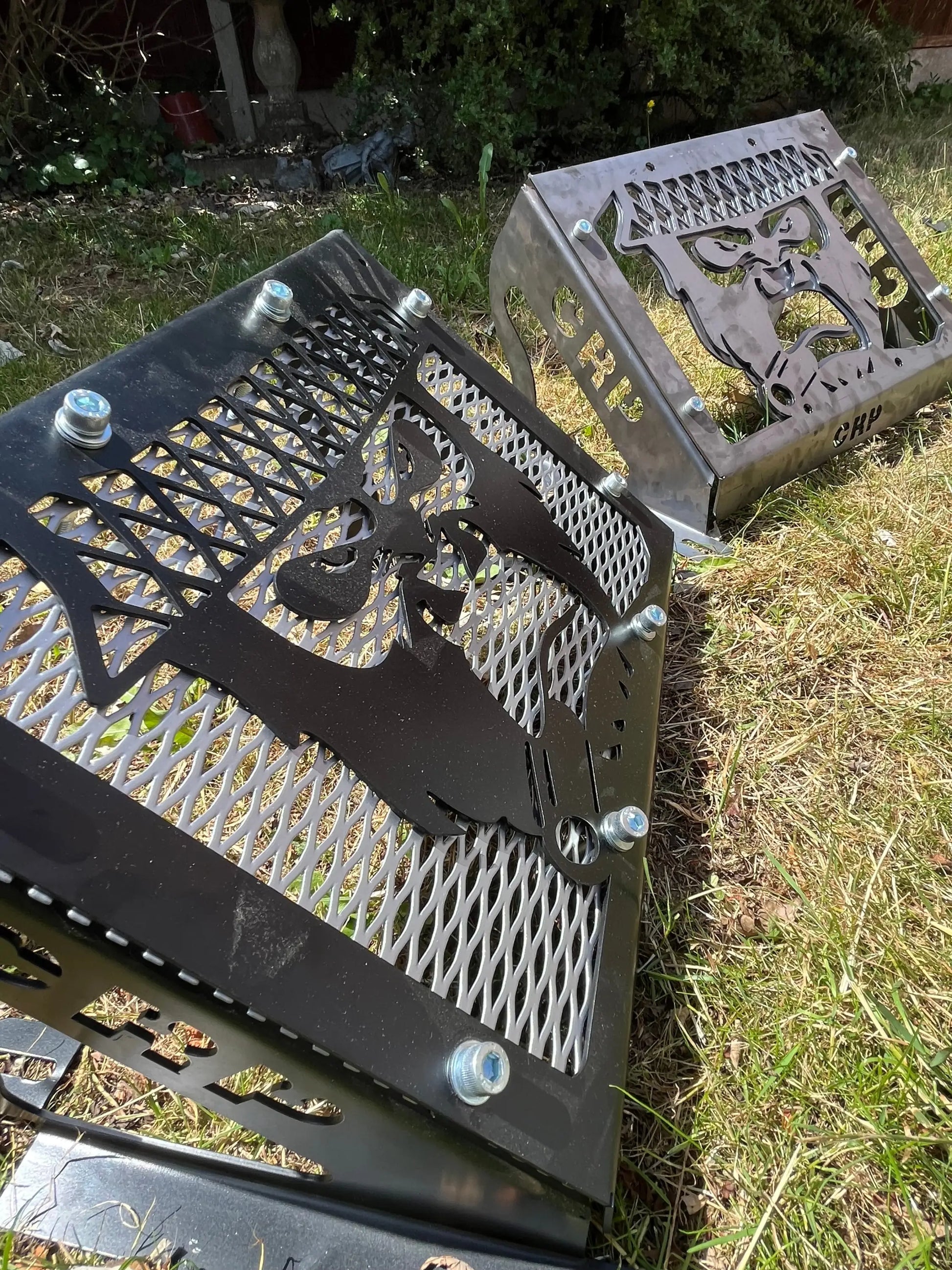 Black metal grill grates with intricate cartoon animal cutouts for yamaha grizzly 550 700 radiator relocation kit