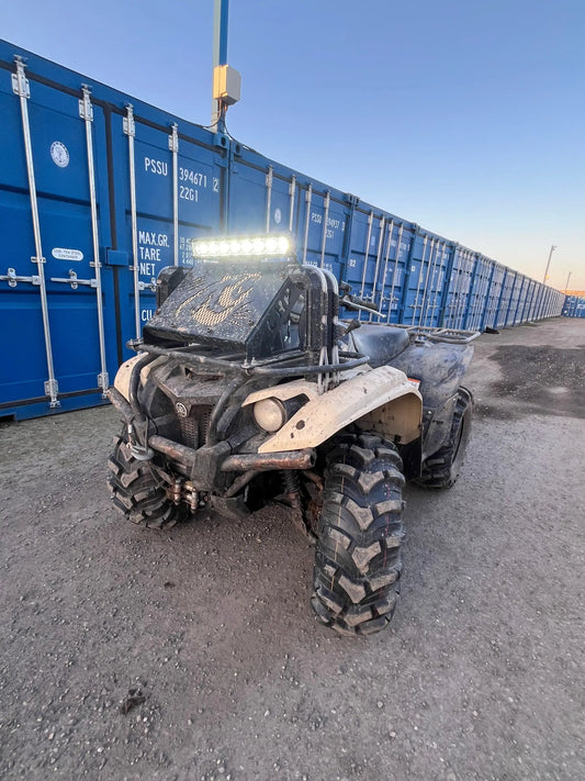 Beige and black yamaha yfz450 off-road atv with rugged tires and front light bar shown with radiator relocation kit