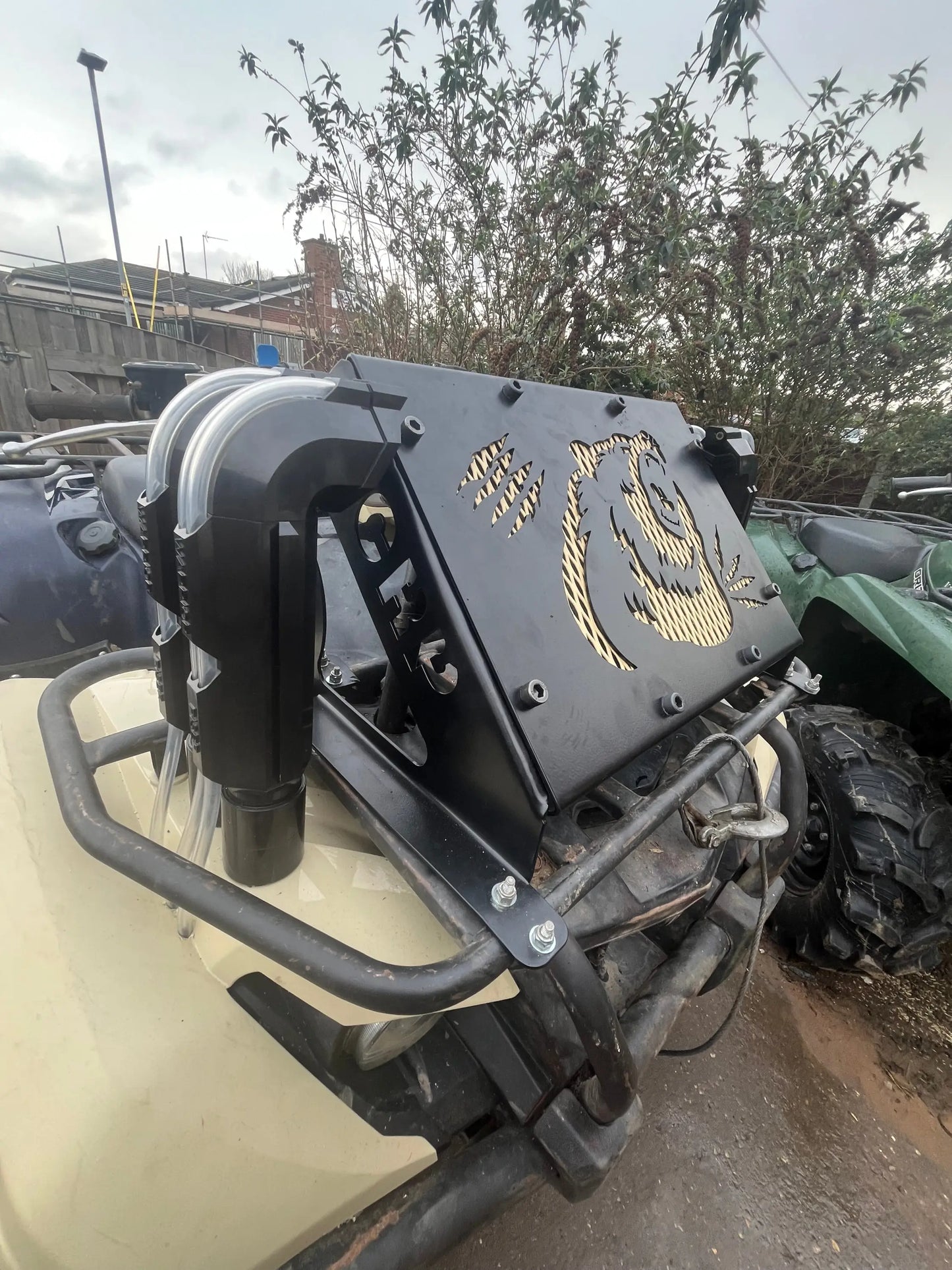 Black metal front guard with gold-painted panda design mounted on atv for Yamaha Grizzly Kodiak 700 radiator relocation kit