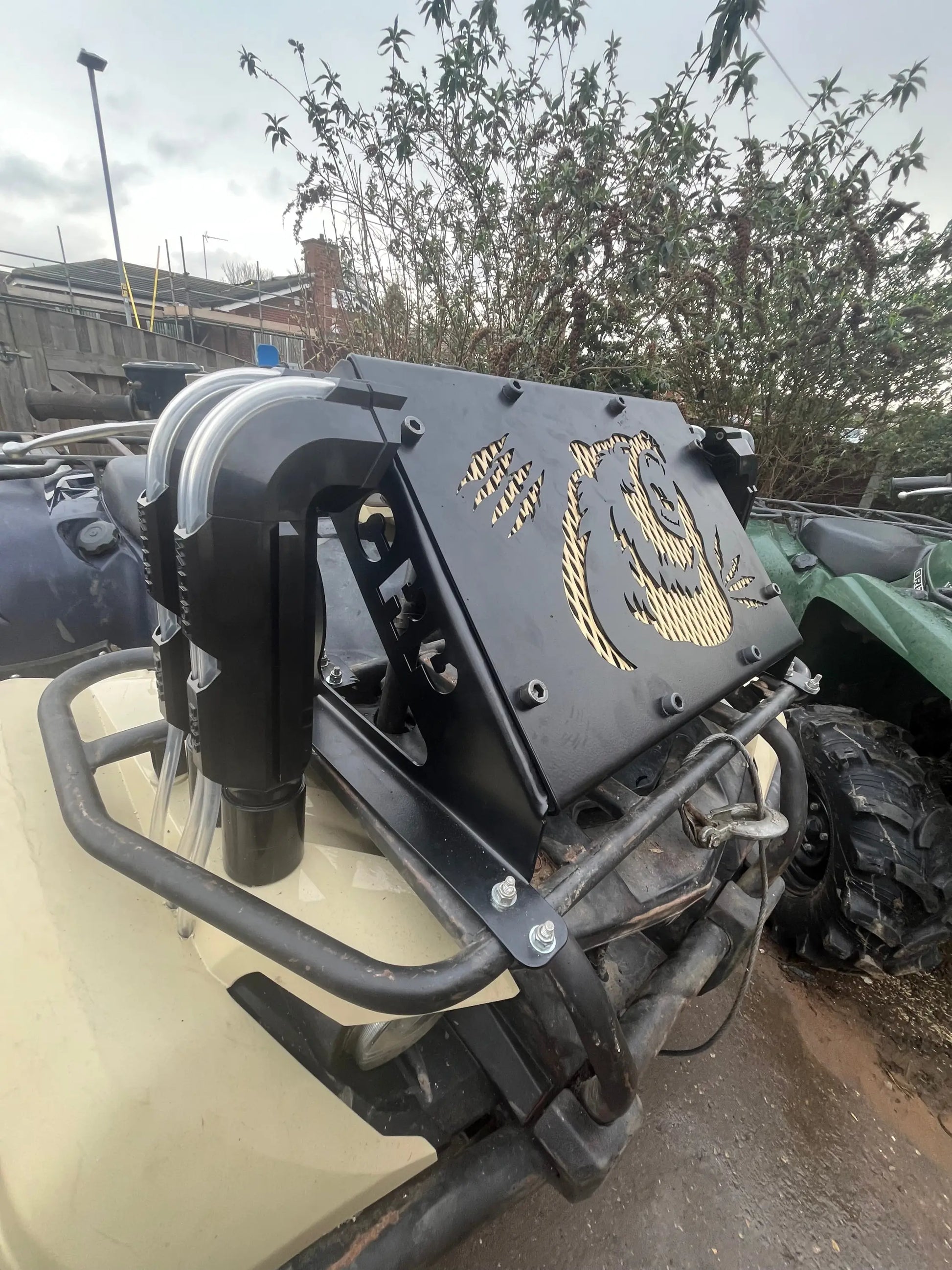 Black metal front guard with gold-painted panda design mounted on atv for Yamaha Grizzly Kodiak 700 radiator relocation kit