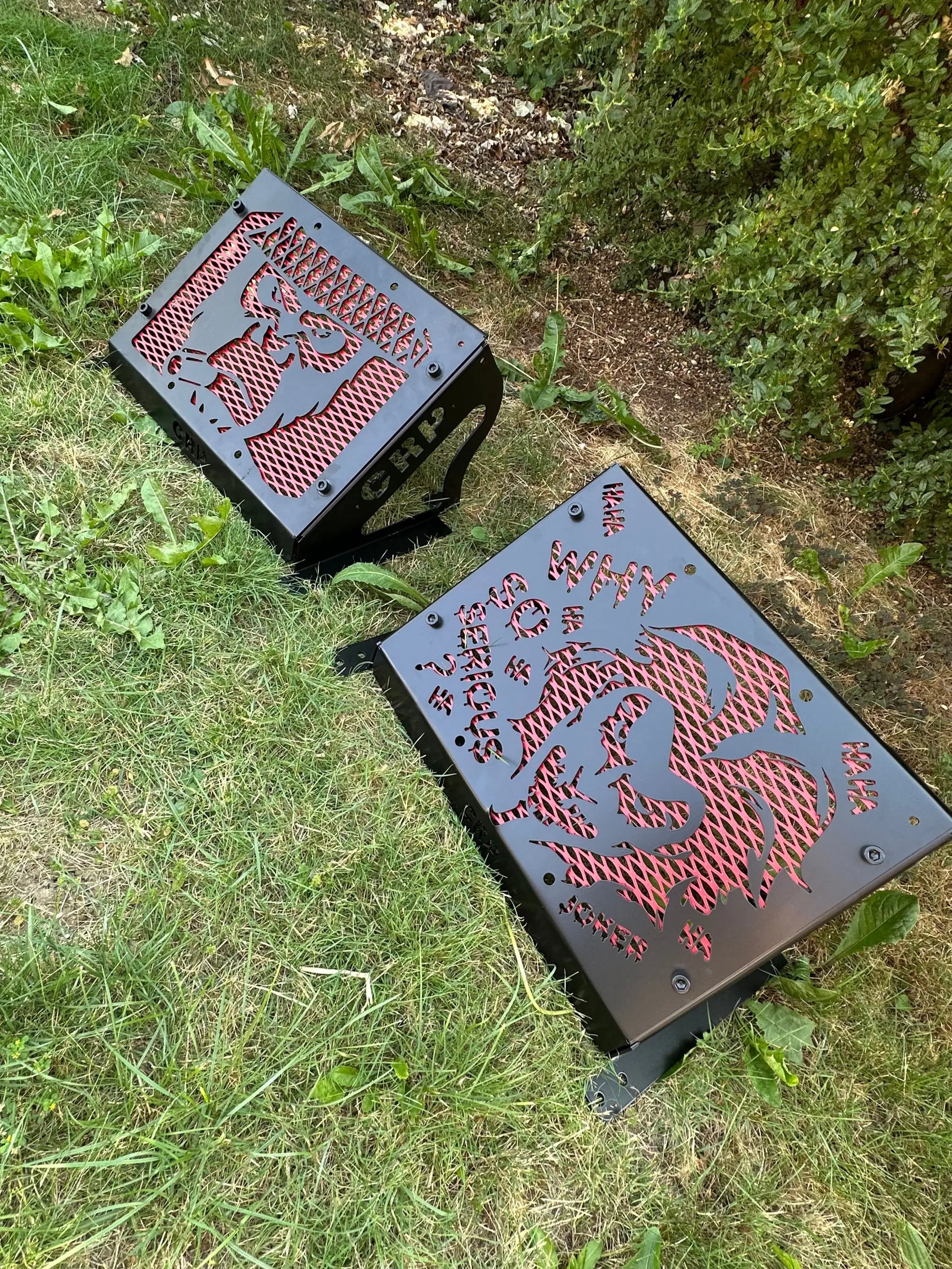 Black metal outdoor fire pits with red laser-cut designs and text for yamaha grizzly kodiak 700 radiator relocation kit