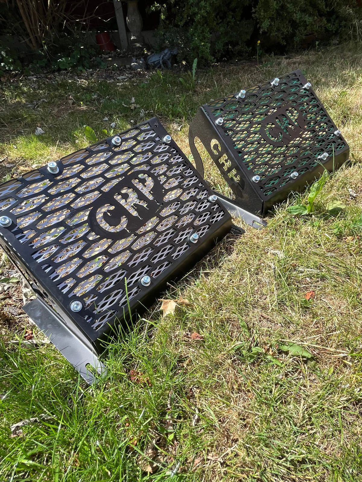 Black metal grates with diamond mesh and silver bolts embossed with crp logos for yamaha grizzly kodiak 700 radiator kit