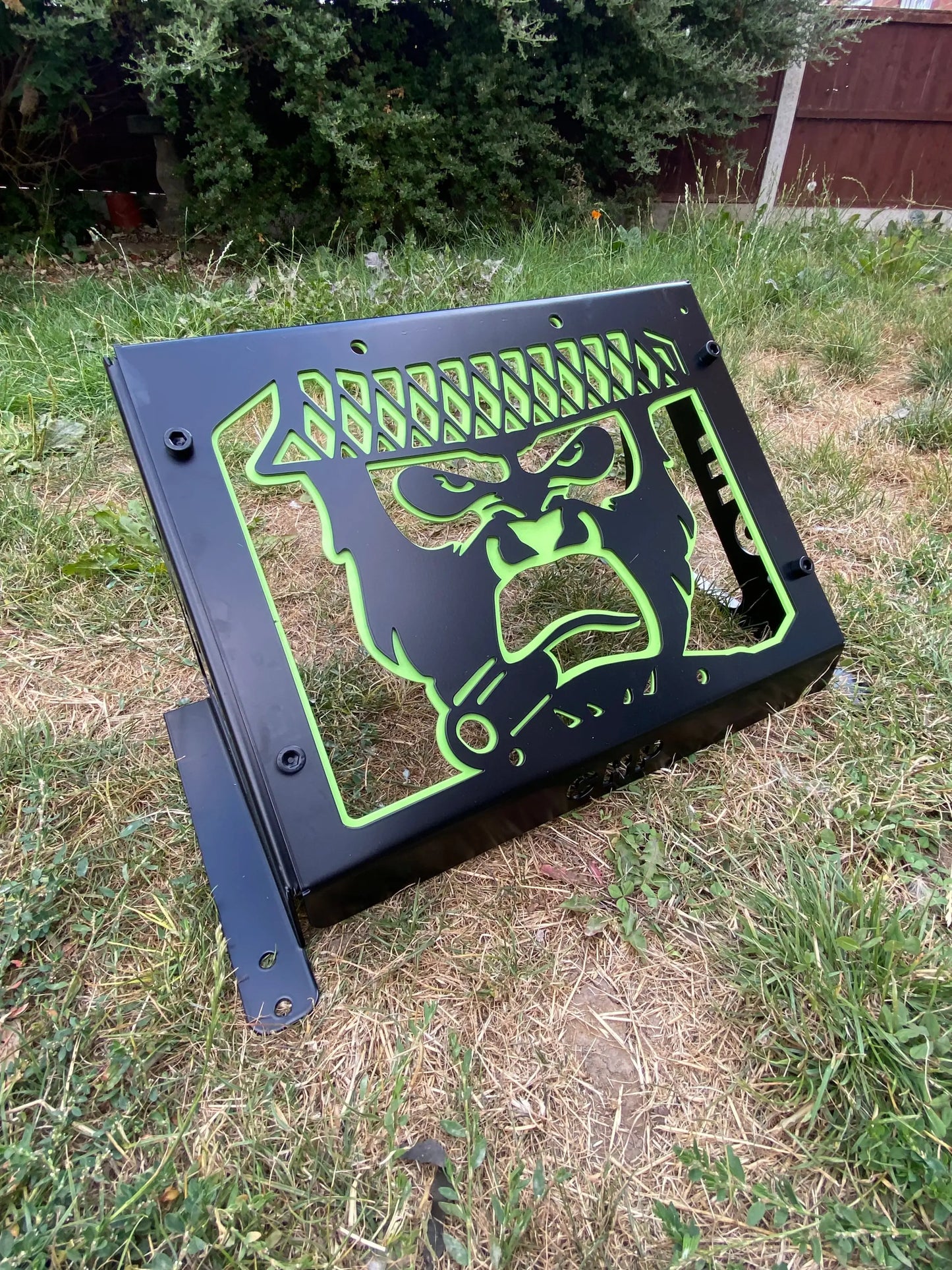 Black metal laptop stand with glowing neon green stylized gorilla face design for Yamaha Grizzly Kodiak 700 radiator kit