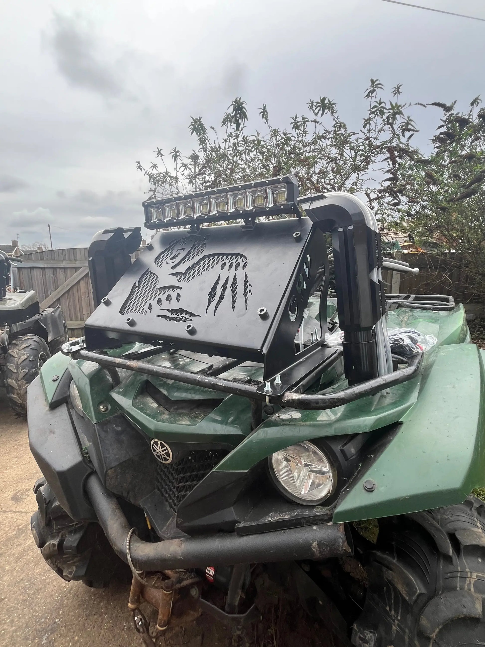 Green yamaha grizzly/kodiak 700 atv with black metal front guard engraved skull and claw design and led light bar